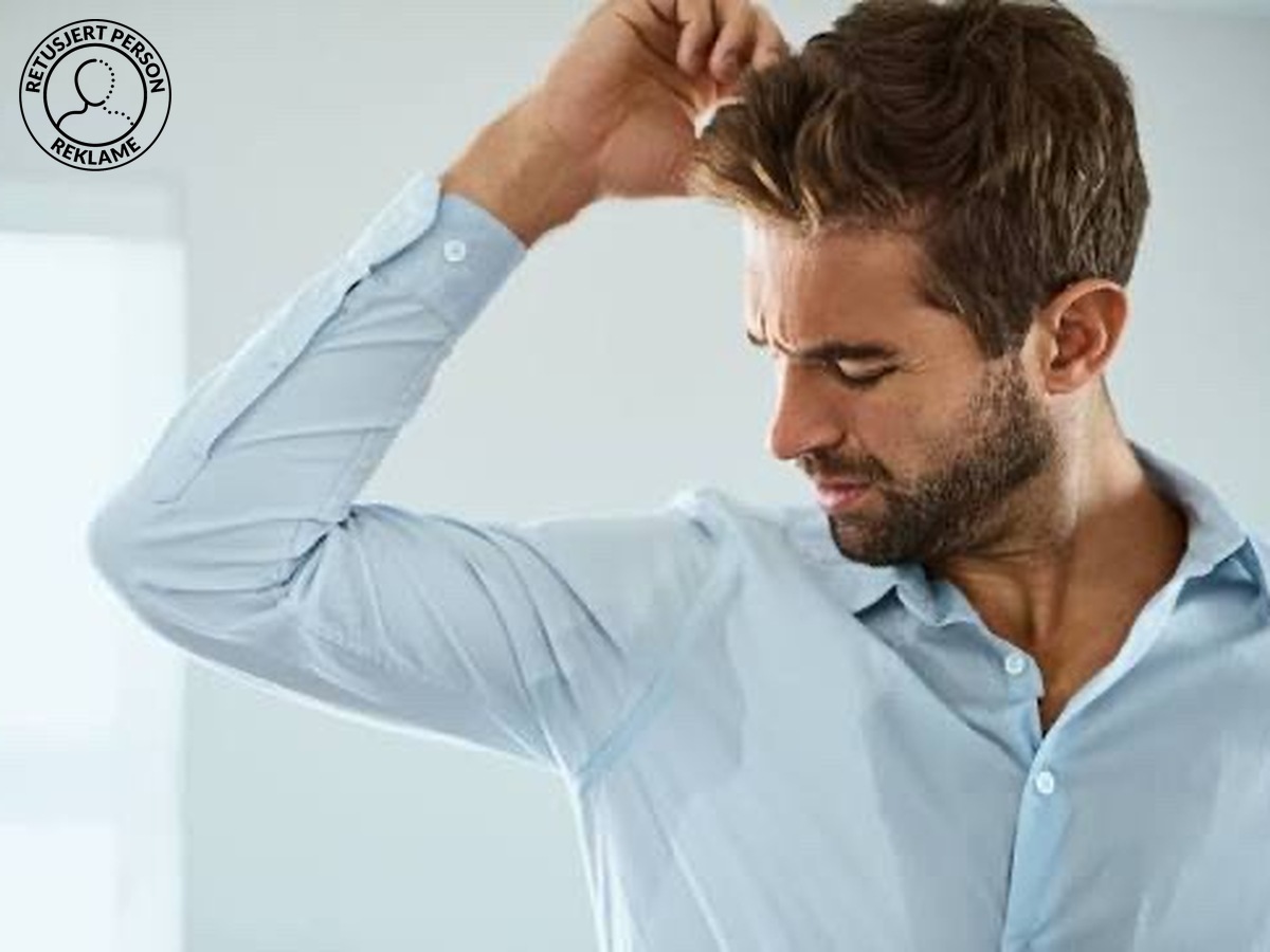 Mann med svetteflekk under armen – svettebehandling pris